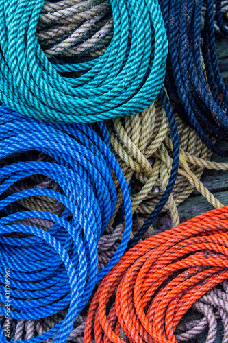 Colorful coiled ropes on dock