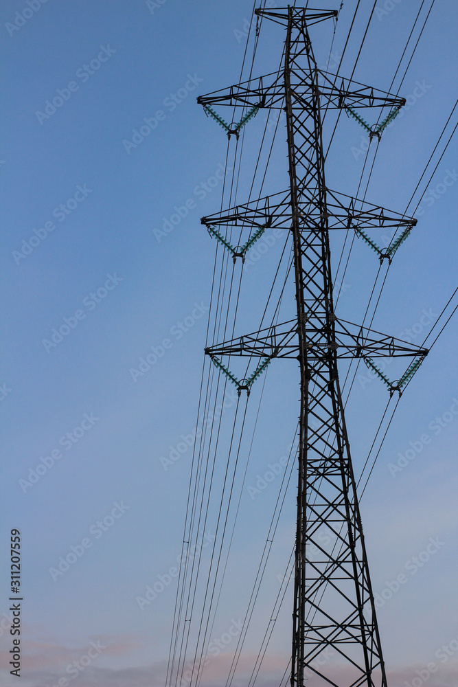 Power transmission tower on background of sunset sky Power transmission tower on background of sunset sky