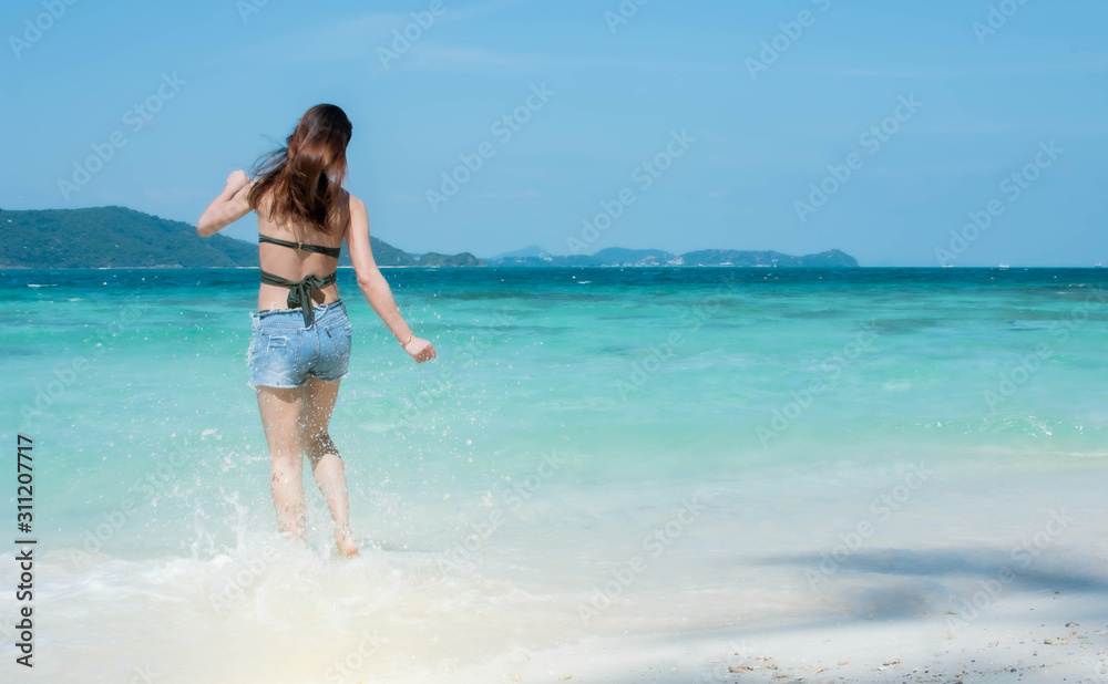 Woman walking on the beach