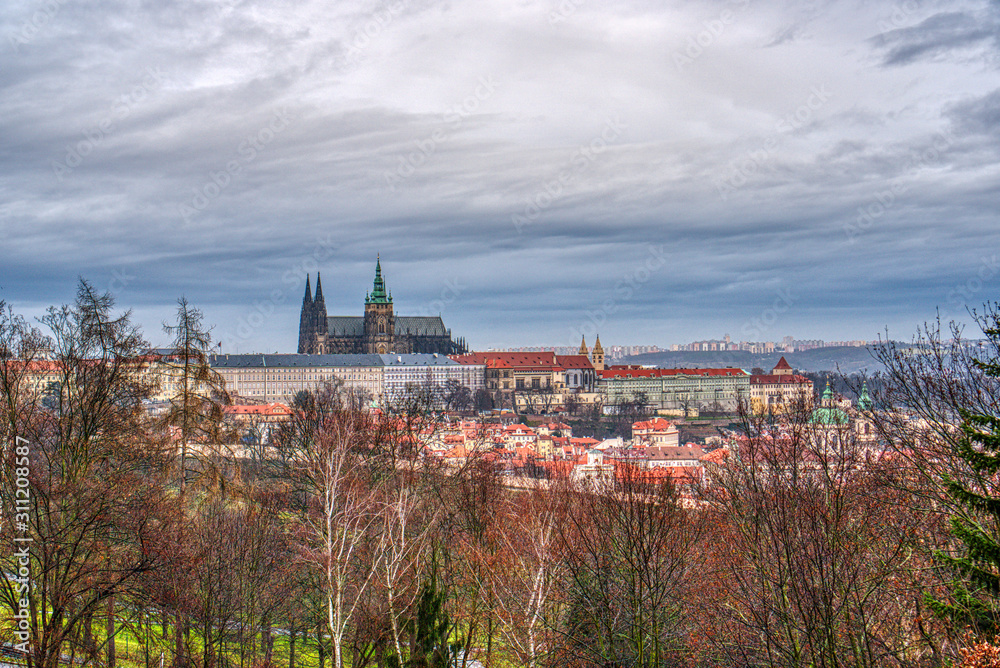 View of the little side in historical part of Prague with cathedral and castle over orchard