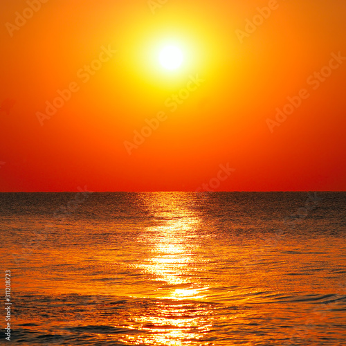 Bright sunrise over the sea. © alinamd