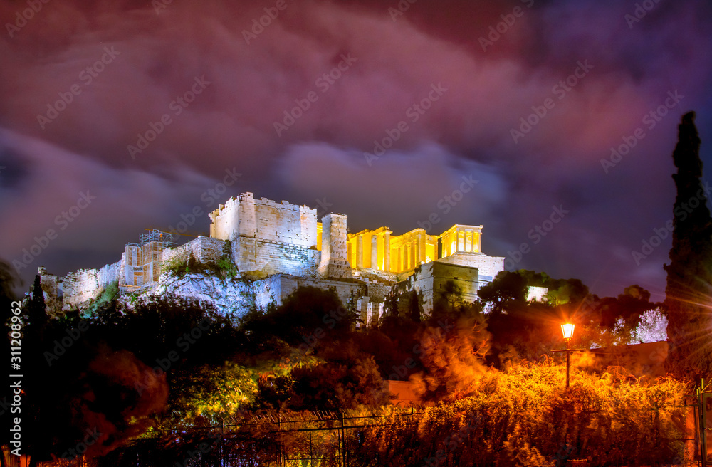 Illuminated Acropolis with Parthenon and nice clouds at night, Athens, Greece.
