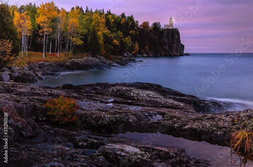 lighthouse on high cliff in autumn