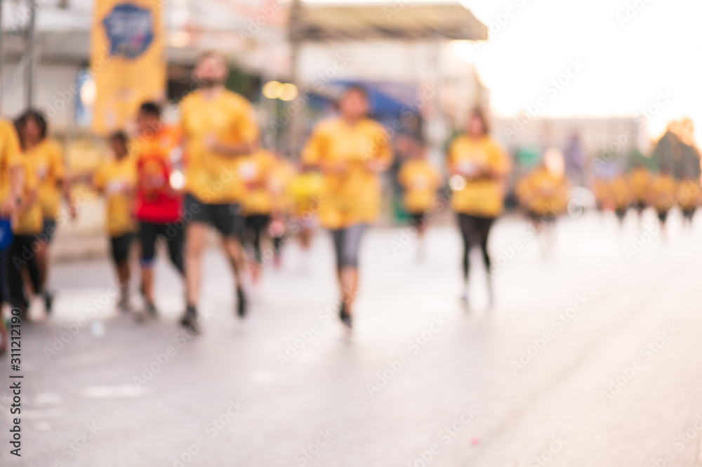 Out of focus and blurry background of marathon running race at the city road in the morning time.Family outdoor exercise for healthy.