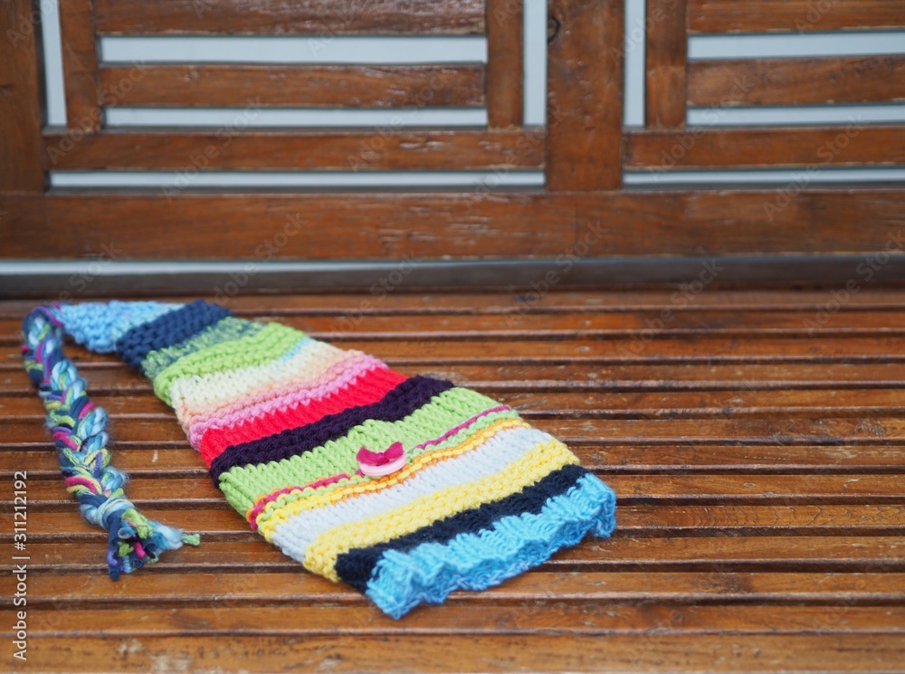 knit elf hat on a wooden bench knit elf hat on a wooden bench