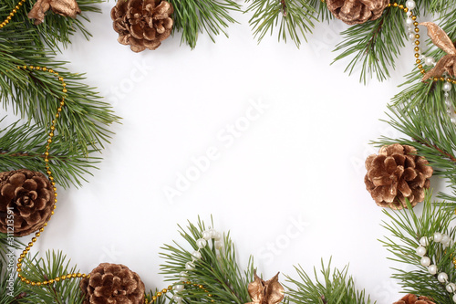 Christmas backdrop with pine branches and cones on a white