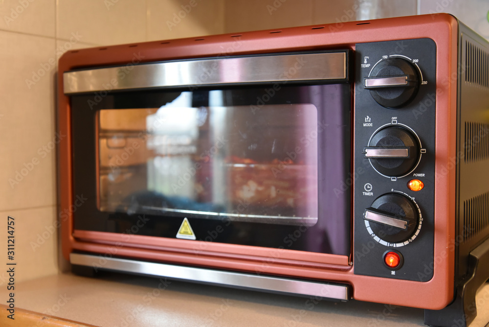 Fototapeta premium Cooking in the Kitchen With Oven