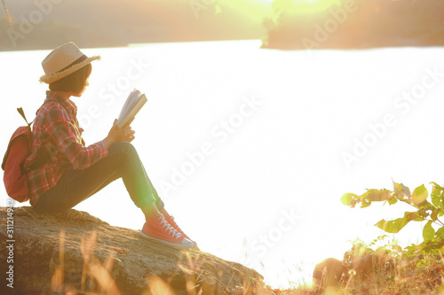 Stockfoto Pretty relaxed young woman reading a book in quiet nature,  concept read a books. | Adobe Stock