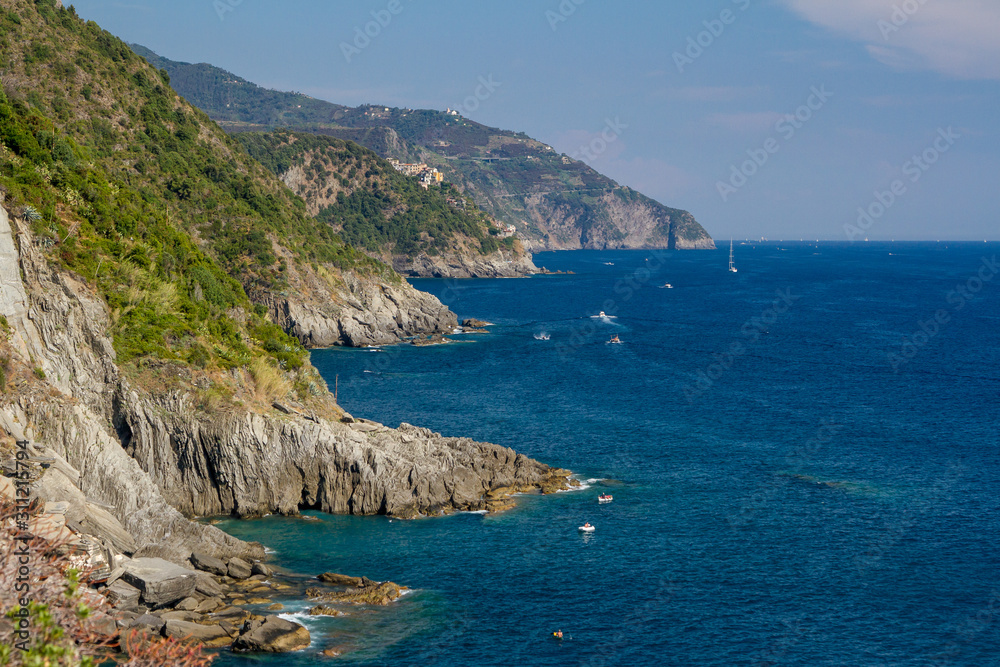 Rocky coast near Riomaggiore with part of the Love Road (Via dell'Amore) in Cinque Terre National Park, Italy