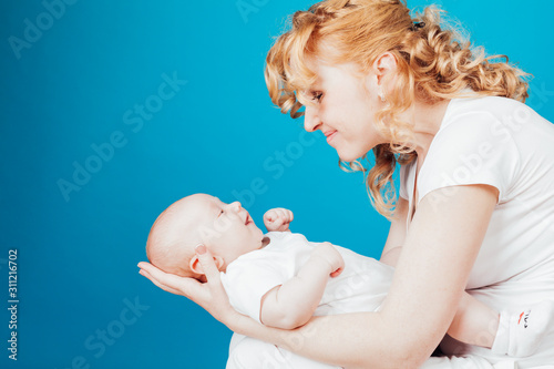 Portrait of a mother with a baby in her arms her son