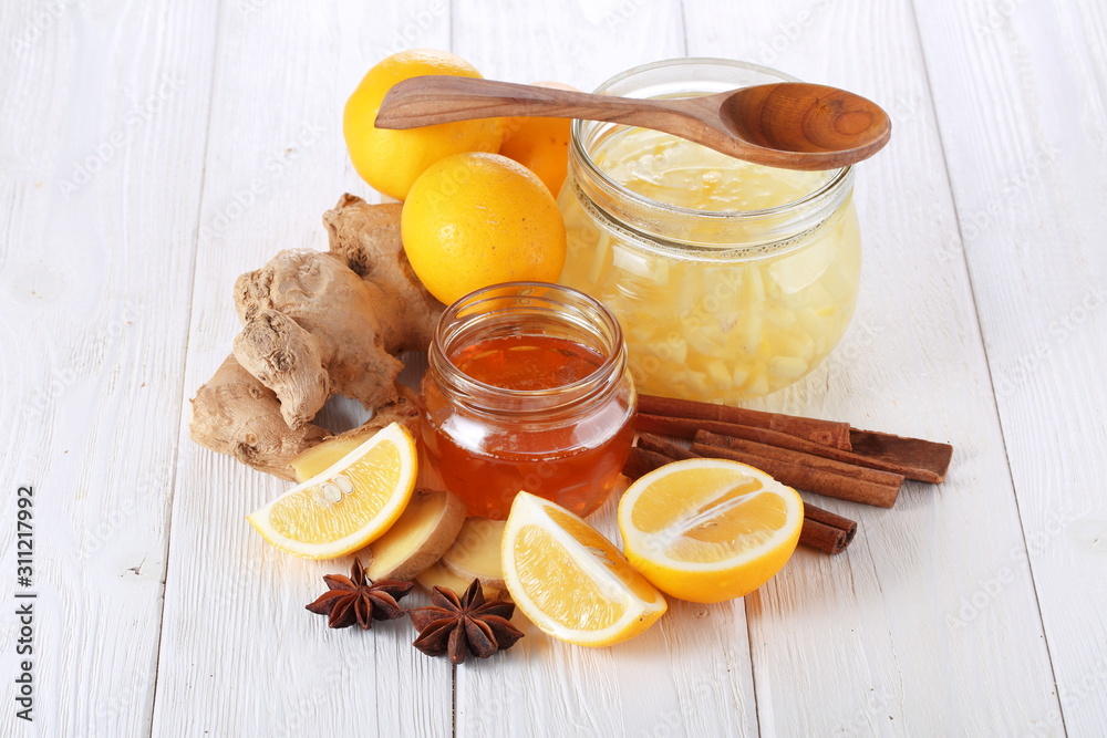 Still life with lemon, ginger and honey on a white background Still life with lemon, ginger and honey on a white background