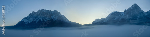 The Ehrwalder Sonnenspitze and the Wetterstein Mountains  The Zugspitze on the left aerial above the clouds and fog  panorama view  Lermoos  Tyrol  Austria  Alps  Europe