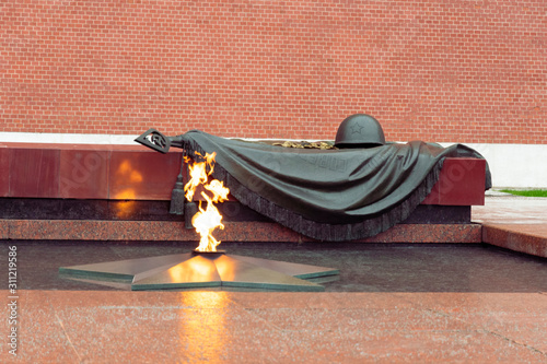Tomb of the Unknown Soldier with a burning flame, eternal flame near the Kremlin wall in Moscow photo