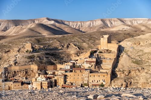 view of the monastery in mar saba against the backdrop of sandy mountains