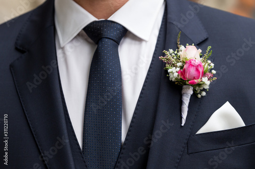groom with wedding bouquet of flowers