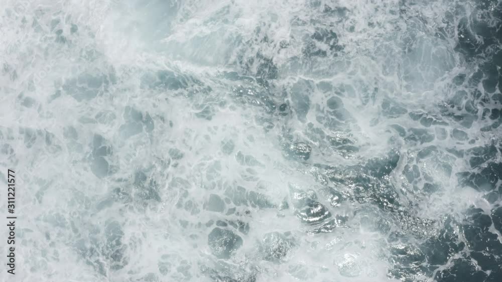 Aerial view of big waves foaming and splashing in sea, Sunny day. Island Bali, Indonesia. Indian ocean.