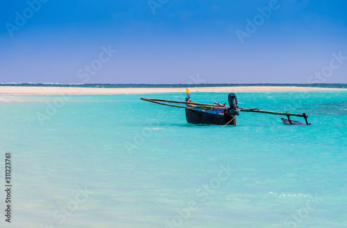 Colored outrigger fishermen pirogue moored on turquoise sea of Nosy Ve island, Indian Ocean, Madagascar © SimoneGilioli