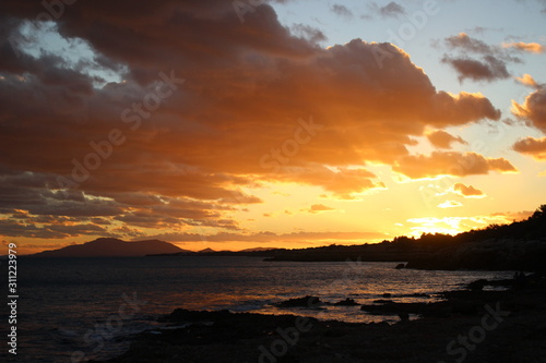 Sunset sea rocks mountain