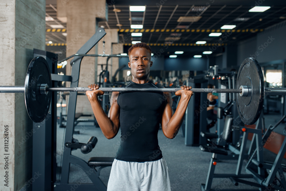Athlete doing exercise with barbell in gym Athlete doing exercise with barbell in gym
