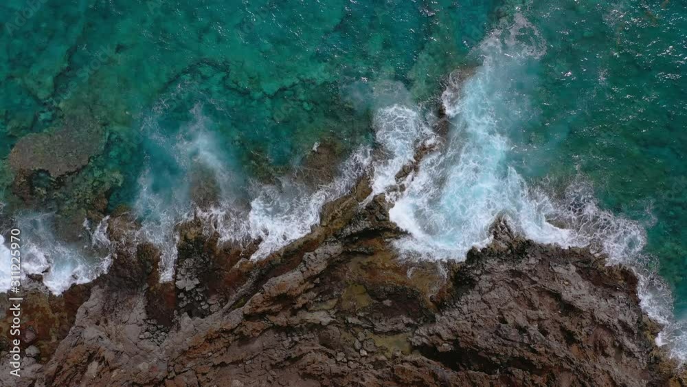Top view of a deserted coast. Rocky shore of the island of Tenerife. Aerial drone footage of ocean waves reaching shore Top view of a deserted coast. Rocky shore of the island of Tenerife. Aerial drone footage of ocean waves reaching shore