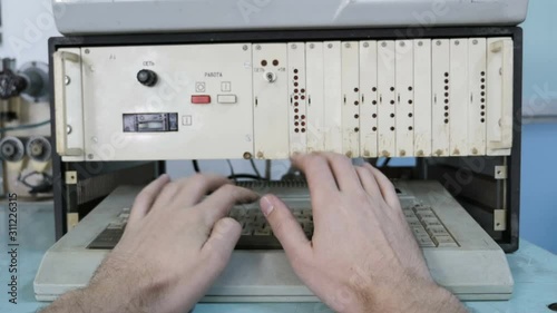 Man Typing On Old Keyboard