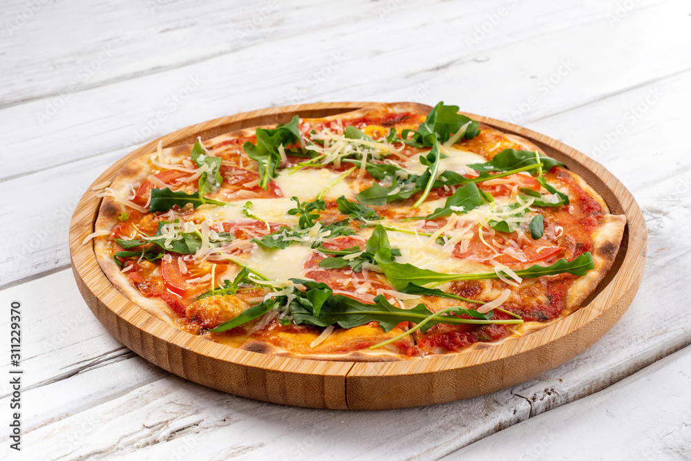 Italian pizza margherita with mozzarella tomatoes and herbs
