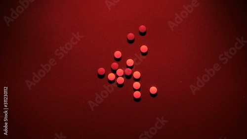 The tablets are randomly scattered. The light flashes red and blue like a police siren. The concept of the dangers of drugs and narcotic substances, overdose and suicide, crime and drug business. Soci
