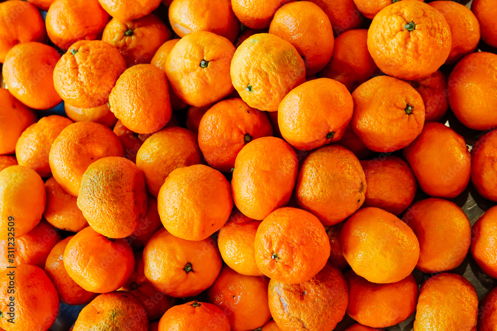 lots of ripe orange tangerine fruit for eating as background