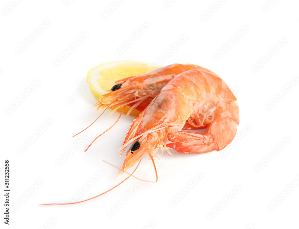 Delicious cooked shrimps and lemon isolated on white Delicious cooked shrimps and lemon isolated on white