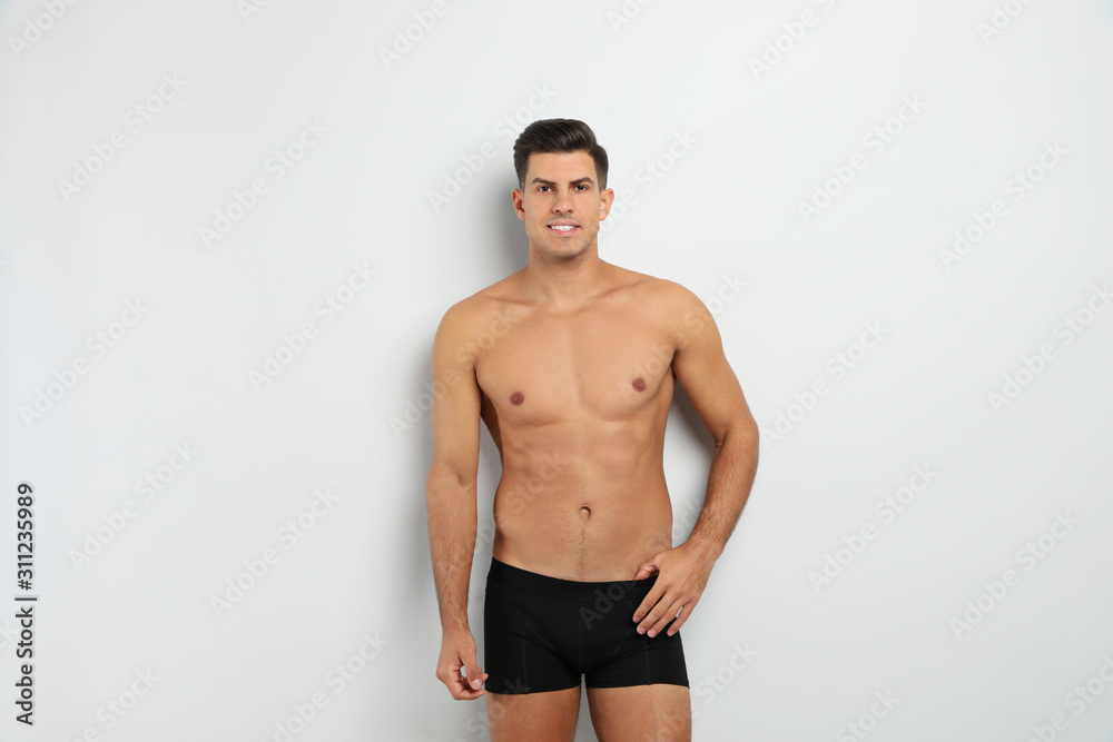 Handsome man in black underwear on white background Handsome man in black underwear on white background