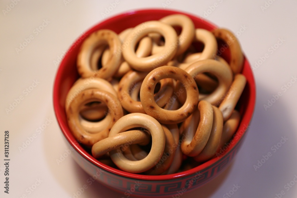 Red clay cup with steering-wheels bagels to eat for tea Red clay cup with steering-wheels bagels to eat for tea