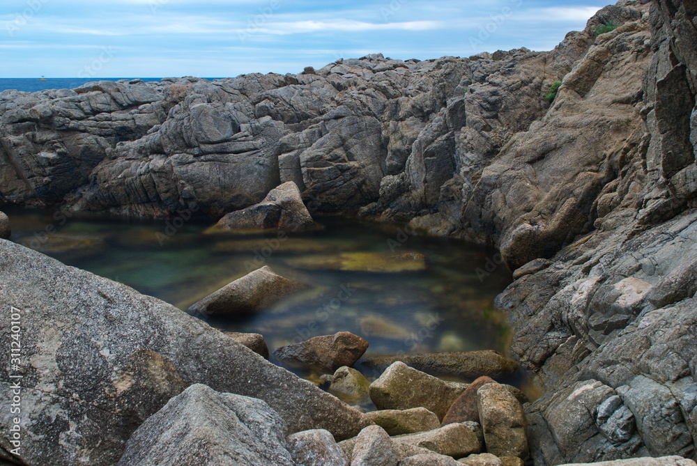 Barcelona, Spain - 18.08.2019: Beautiful cliffs on the Spanish coast of the Mediterranean Sea Barcelona, Spain - 18.08.2019: Beautiful cliffs on the Spanish coast of the Mediterranean Sea