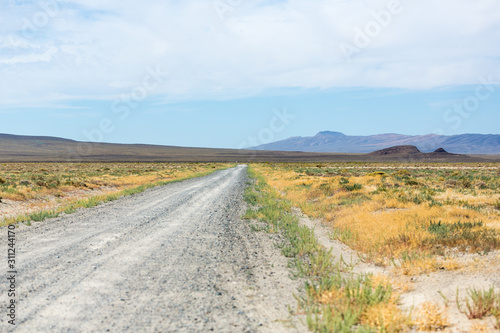 Dirt road running through the middle of the desert and sagebrush