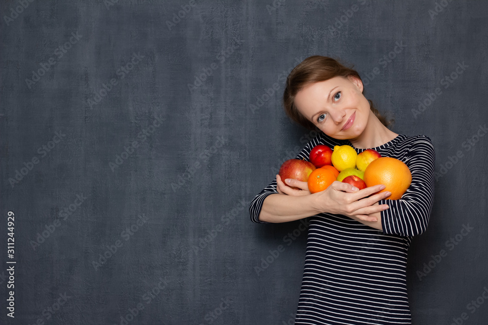 Portrait of happy joyful girl smiling and holding ripe fruits in hands Portrait of happy joyful girl smiling and holding ripe fruits in hands