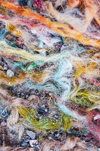 Thick multicolored carpet fibers worn to shreds