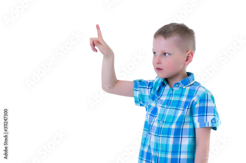 The boy points a finger at something.