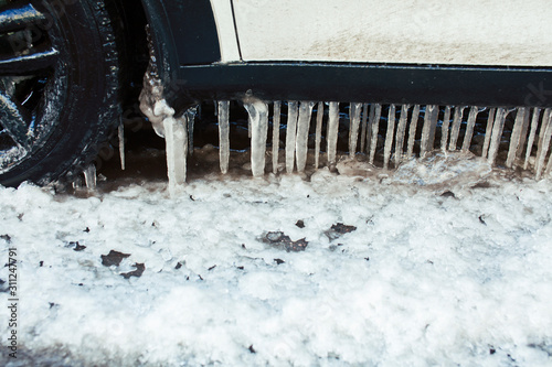 close up photo off car in iciles, a lot of water and snow, seasonal issues concept photo