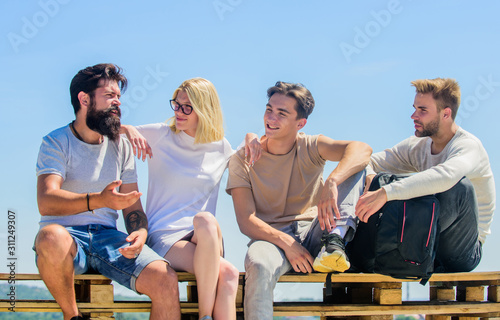 Best weekend ever. group of four people. great fit for day off. Group of people in casual wear. happy men and girl relax. best friends. Summer vacation. diverse young people talking together