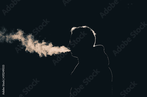 Sillouette of a smoking man in low key