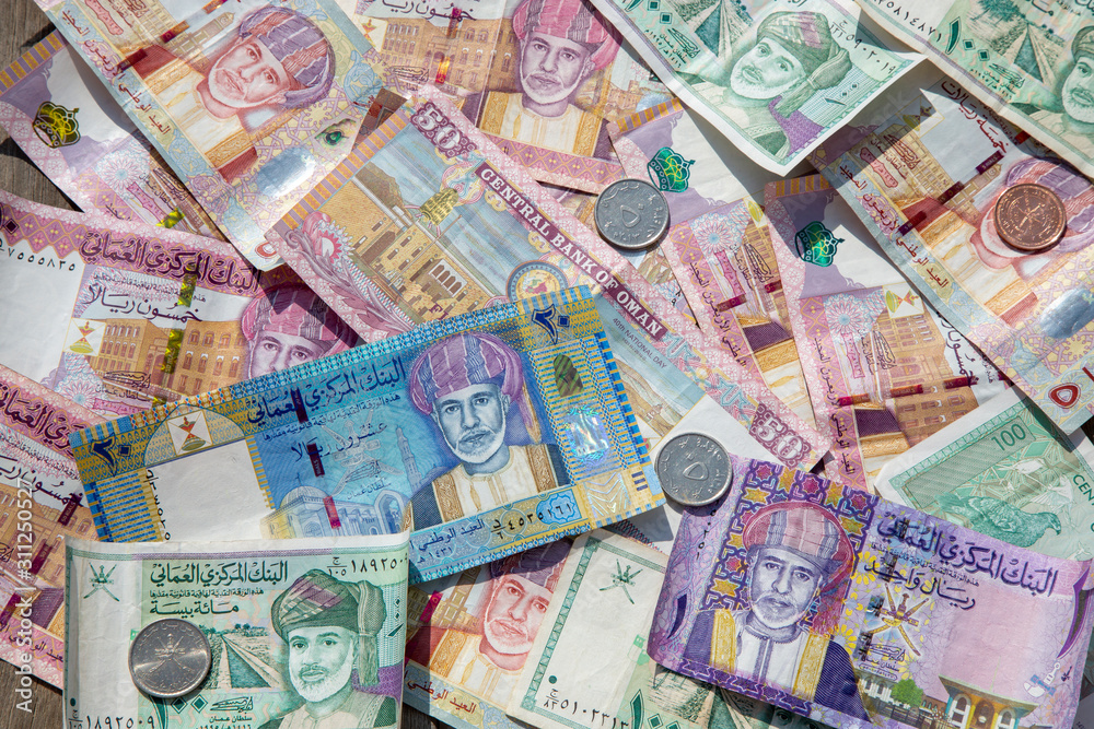 Closeup view of different banknotes and coins of omani rials
