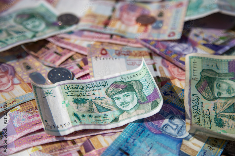 Closeup view of different banknotes and coins of omani rials Closeup view of different banknotes and coins of omani rials