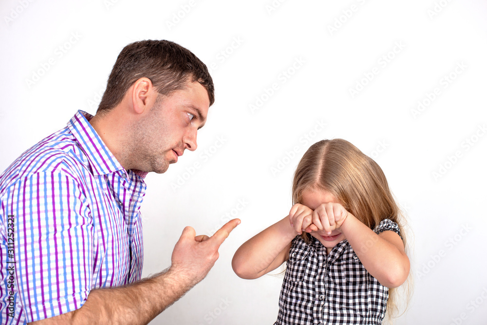 Shot of an angry father scolding or punishing a little daughter. Shot of an angry father scolding or punishing a little daughter.