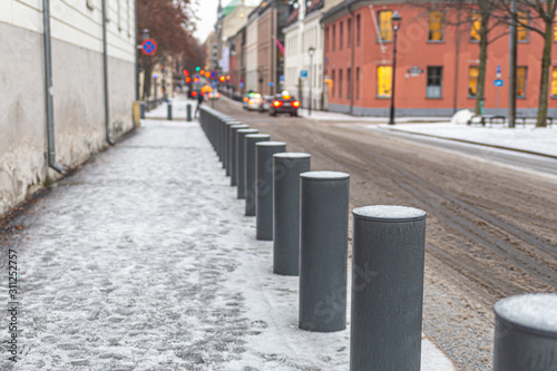 Small metal road poles covered with frost and snow