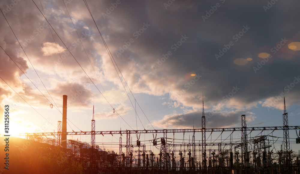 Pylons and power lines at dusk. Industrial landscape