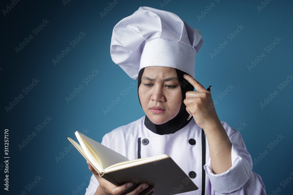 Woman Chef Reading Book of Recipes Woman Chef Reading Book of Recipes