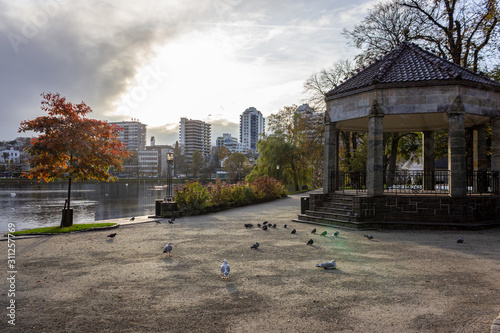 City park of Stavanger with lake, pavilion and skyline, Norway