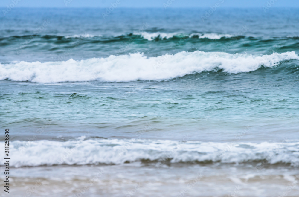 Raudasandur or red sandy beach in the westfjords of Iceland. Green and bluish waves are crashing ashore. Ocean, traveling and nature concept. Raudasandur or red sandy beach in the westfjords of Iceland. Green and bluish waves are crashing ashore. Ocean, traveling and nature concept.