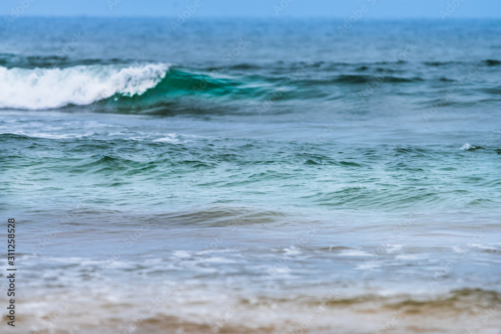 Raudasandur or red sandy beach in the westfjords of Iceland. Green and bluish waves are crashing ashore. Ocean, traveling concept. Raudasandur or red sandy beach in the westfjords of Iceland. Green and bluish waves are crashing ashore. Ocean, traveling concept.