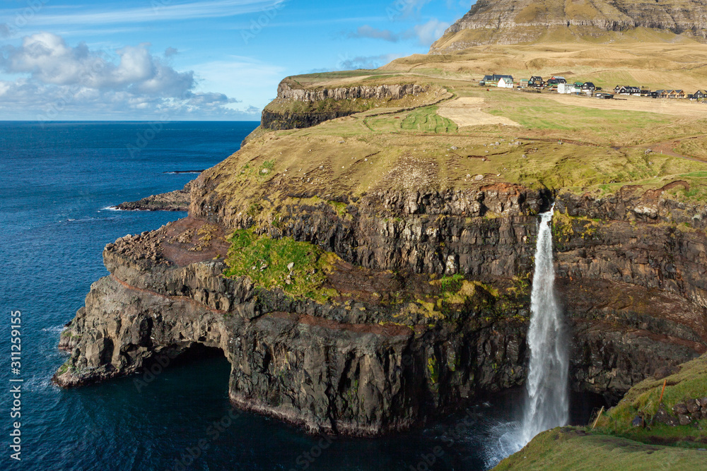 Picturesque waterfall in the village Gasadalur in the Faroe Islands