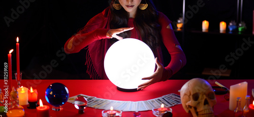 Fortune Teller's Hands are predicting on the crystal ball.